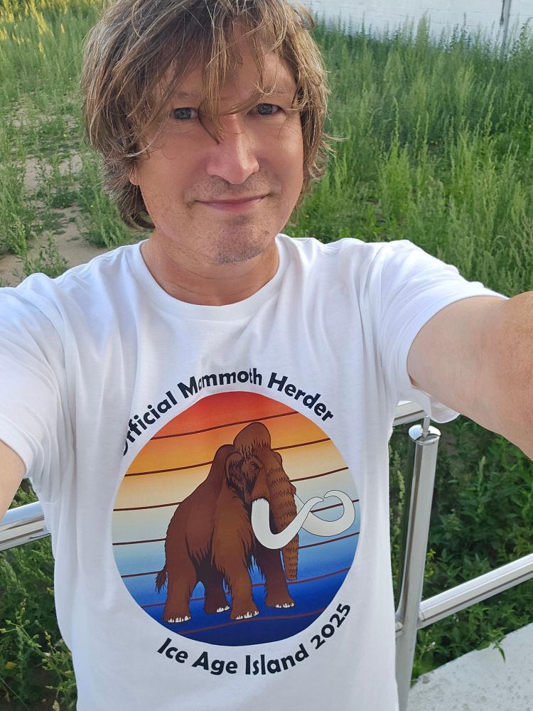 Me in a t shirt showing a mammoth against sunset colors. Text reads "Official Mammoth Herder. IceAgeIsland 2025"
