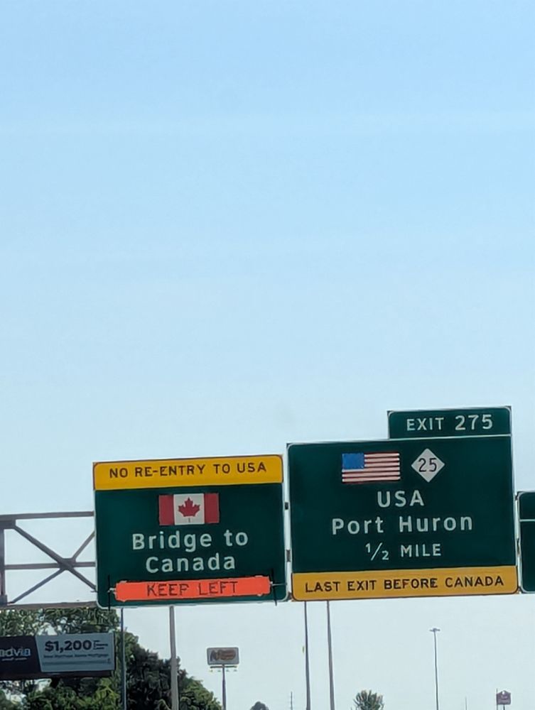 Road signs at the Blue Water Bridge that say Bridge to Canada - No Re-entry to USA - Keep Left 