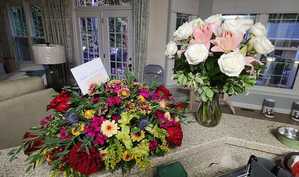 Two bouquets of flowers on a counter