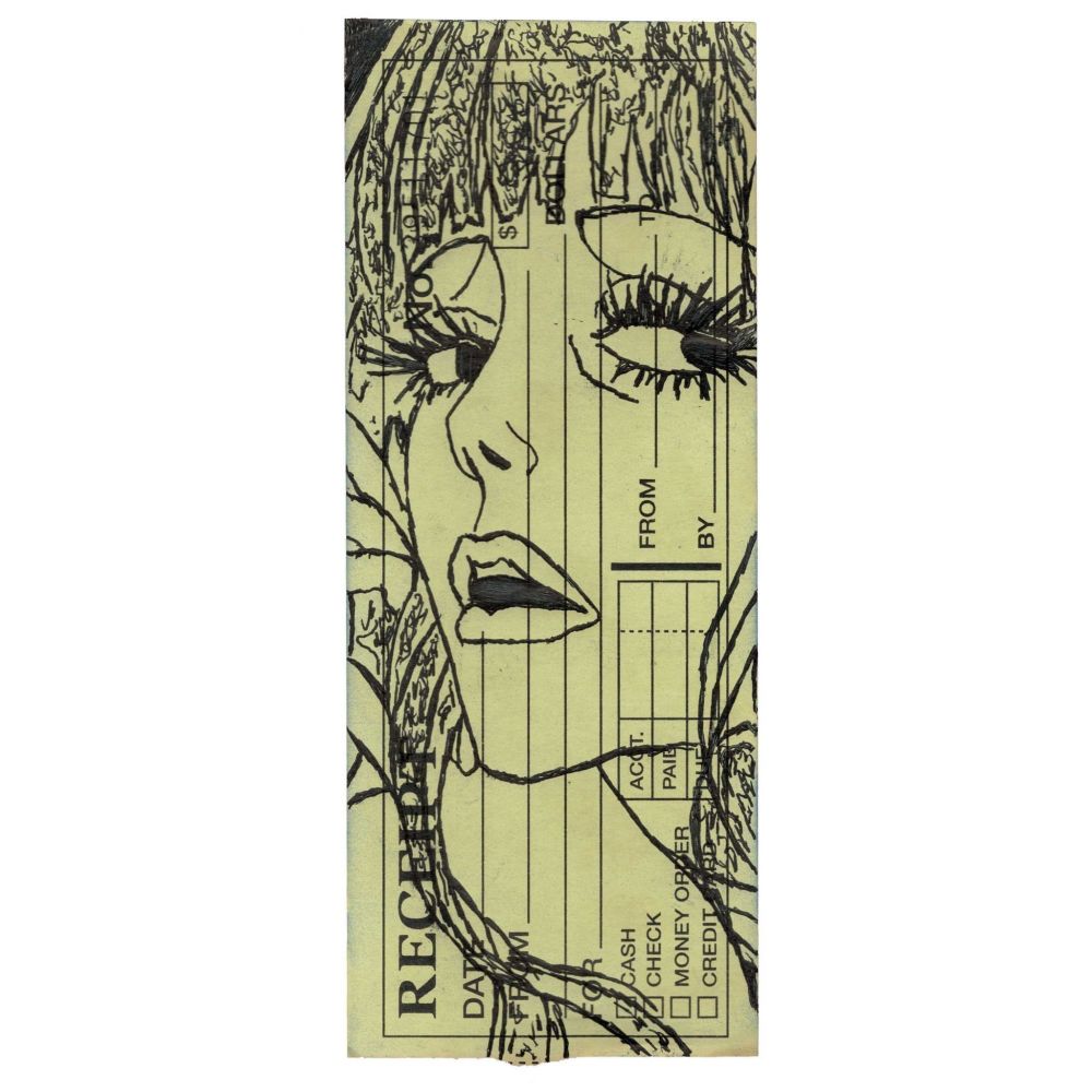 Pen drawing of a smiling anime woman drawn on a torn receipt.