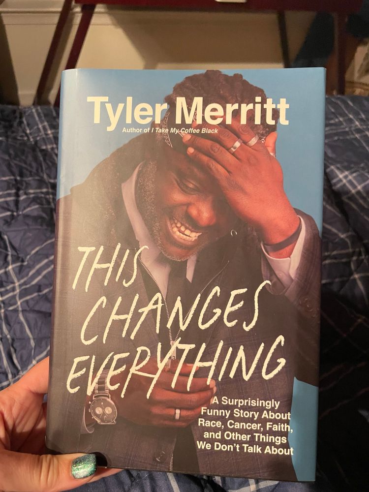 Book Cover, “This Changes Everything” by Tyler Merritt, picturing the author, smiling broadly. 
