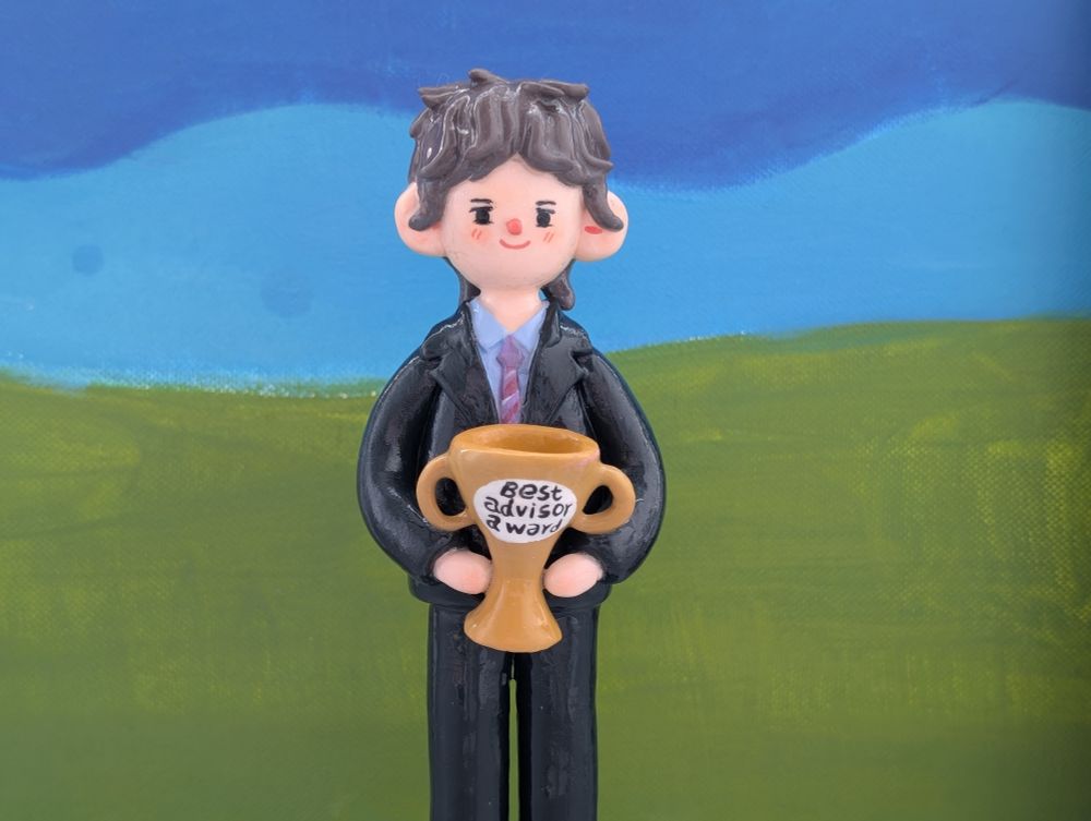 Figurine in Jason's likeness holding a best advisor award.