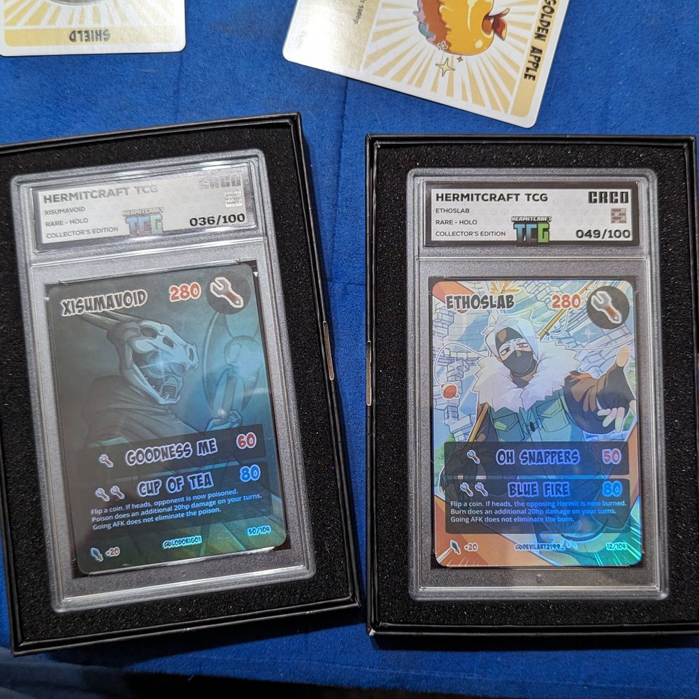 Rare holographic Xisumavoid and Ethoslab cards in protective cases.