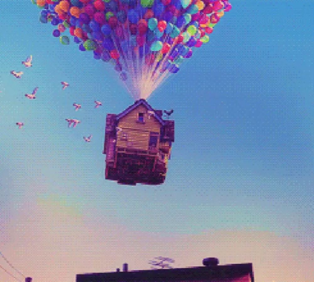 a house is flying through the air with balloons