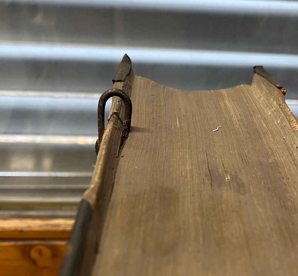 The piercing: a metal thing made to have your book chained to a desk or shelf. 