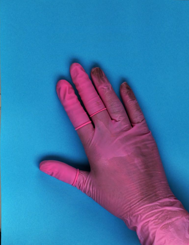 A hand soaked with sweat, in a plastic glove, caught in the act while doing a digital scan of a broadside for a Munich based library. Source: https://www.digitale-sammlungen.de/de/view/bsb10811151?page=6,7
