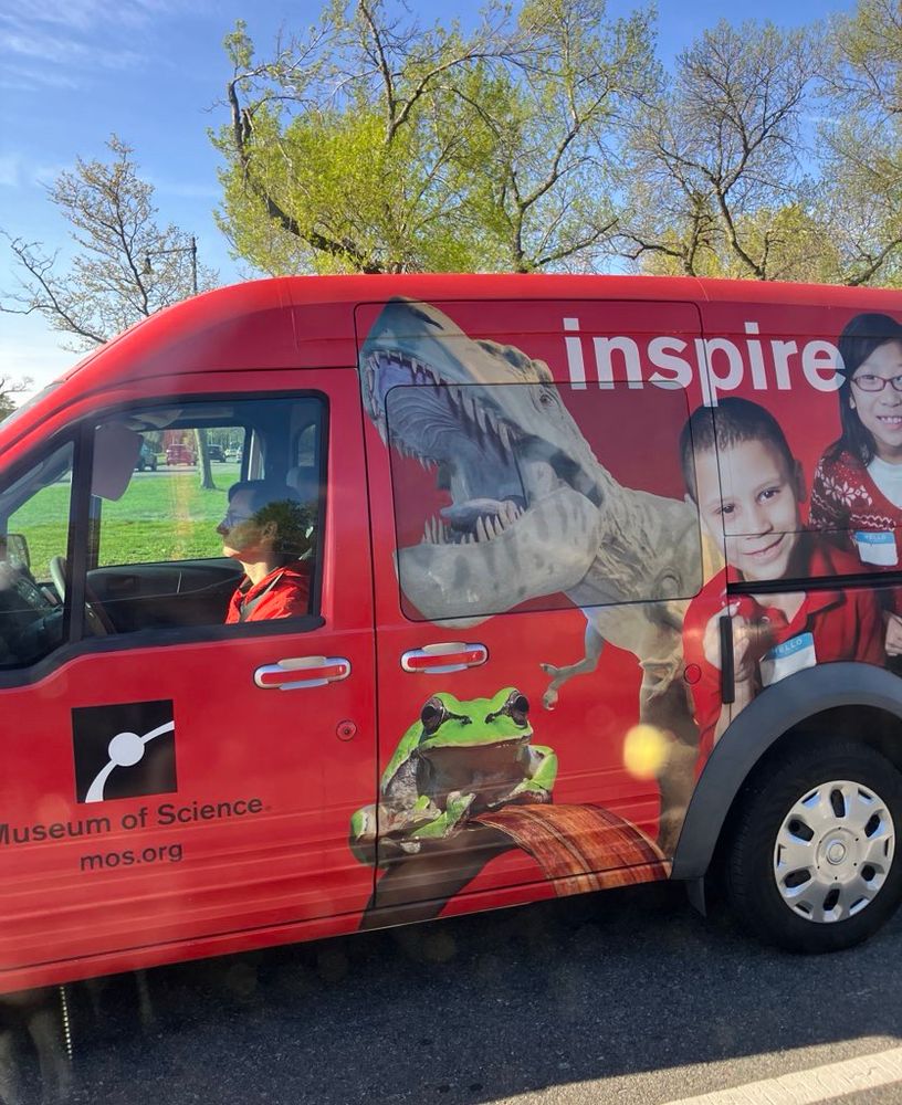Museum of Science van with ginormous T-Rex, frog, and enthusiastic children emblazoned on the side 