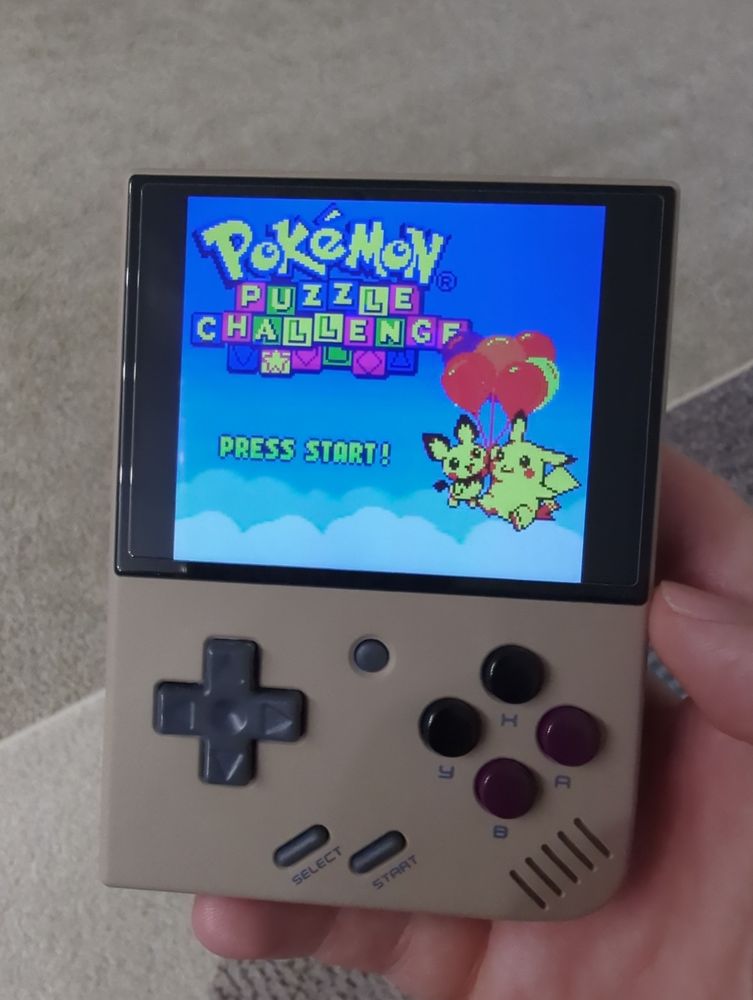 Pokemon Puzzle Challenge running on a gaming handheld that resembles a Game Boy