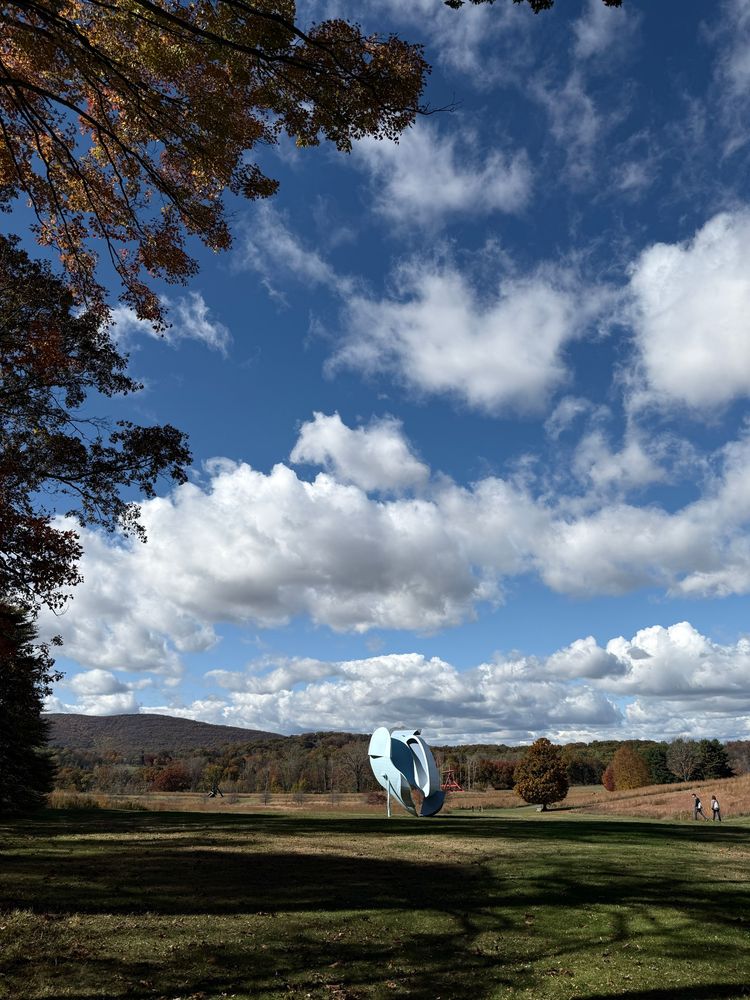 a blue sculpture in the landscape 
