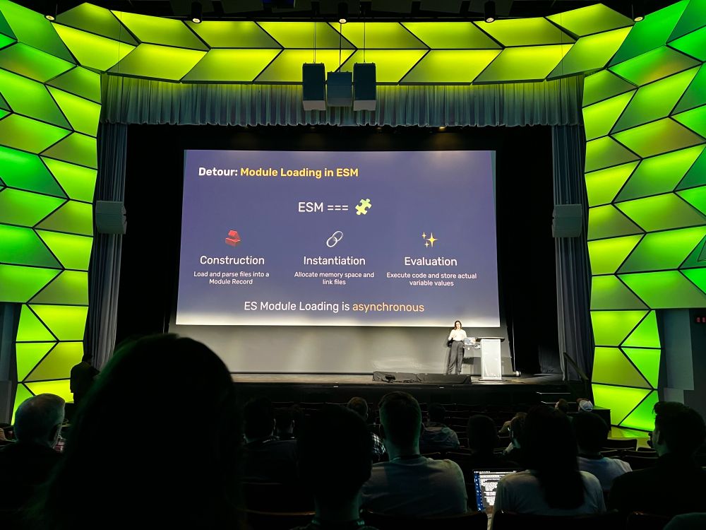 Sigrid on stage with a slide explaining the ES Module loading algorithm. The algorithm consists of three steps: Construction, Instantiation and Evaluation 
