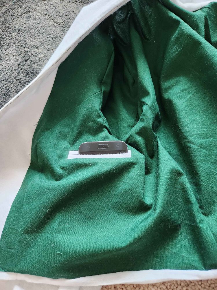 A close-up of the blazer's lining pockets with a phone inside.