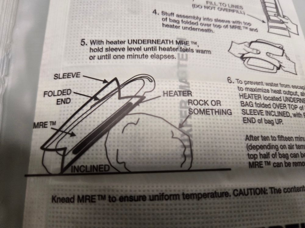 A close up of the instructions, displaying how to lay the heater when activated. It really does say to lay the heater on a "rock or something" on the instructions 