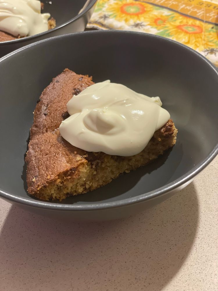 Photo of slice of cookie pie in bowl with cream
