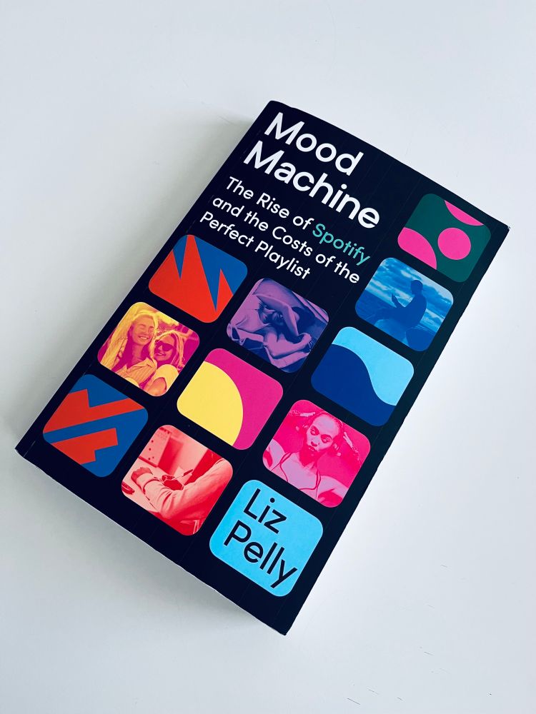 a photo of the book “Mood Machine” written by Liz Pelly. This is a book about the rise of Spotify and the “costs” of the perfect playlist.