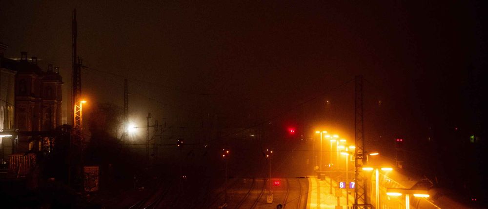 Photo of train tracks during a foggy night.
