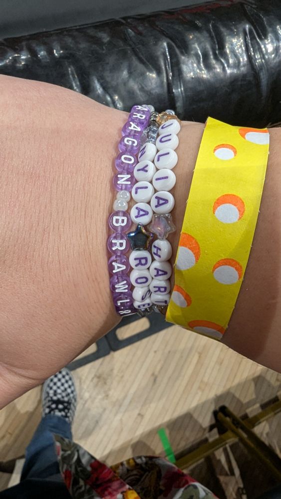 Bracelets featuring the names of Nyla Rose and Julia Hart, as well as one that says "Aragon Brawlroom"