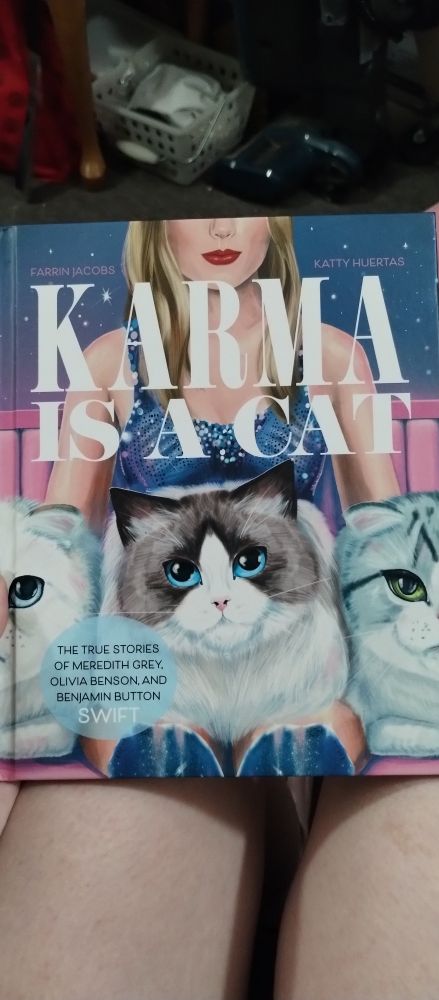 A picture of the book "Karma is a Cat: The True Storiesof Meredith Grey, Olivia Benson, and Benjamin Button Swift" by Farrin Jacobs and Katty Huertas