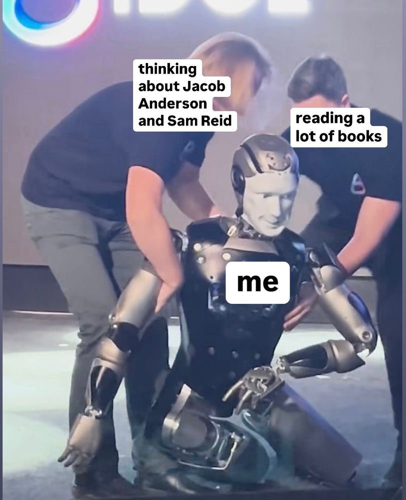 A dumb meme I made of the Russian robot that fell down on stage and two people are trying to help it. The robot is me. I added the words “thinking about Jacob Anderson and Sam Reid” over one person and “reading a lot of books” over the other person. 