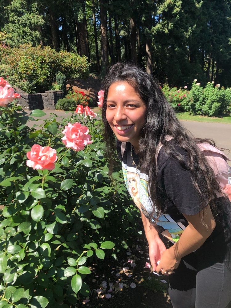 Susan in front of pink flowers