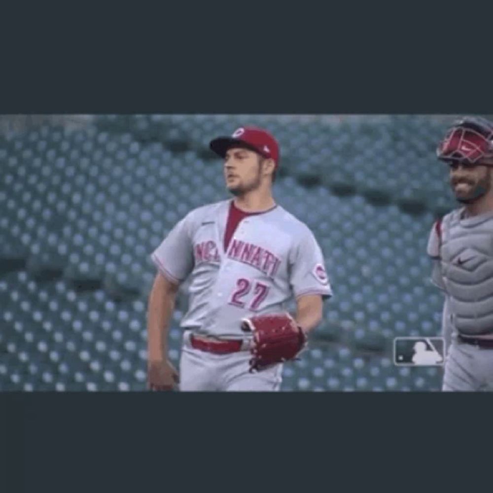 a baseball player with the number 27 on his jersey is walking on the field