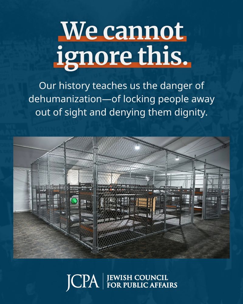 A graphic from the Jewish Council for Public Affairs (JCPA) featuring the text “We cannot ignore this” in bold white and orange letters, followed by the message, “Our history teaches us the danger of dehumanization—of locking people away out of sight and denying them dignity.” Below the text is a photo of a large chain-link cage structure filled with rows of bunk beds, resembling a detention facility. The JCPA logo appears at the bottom of the image.