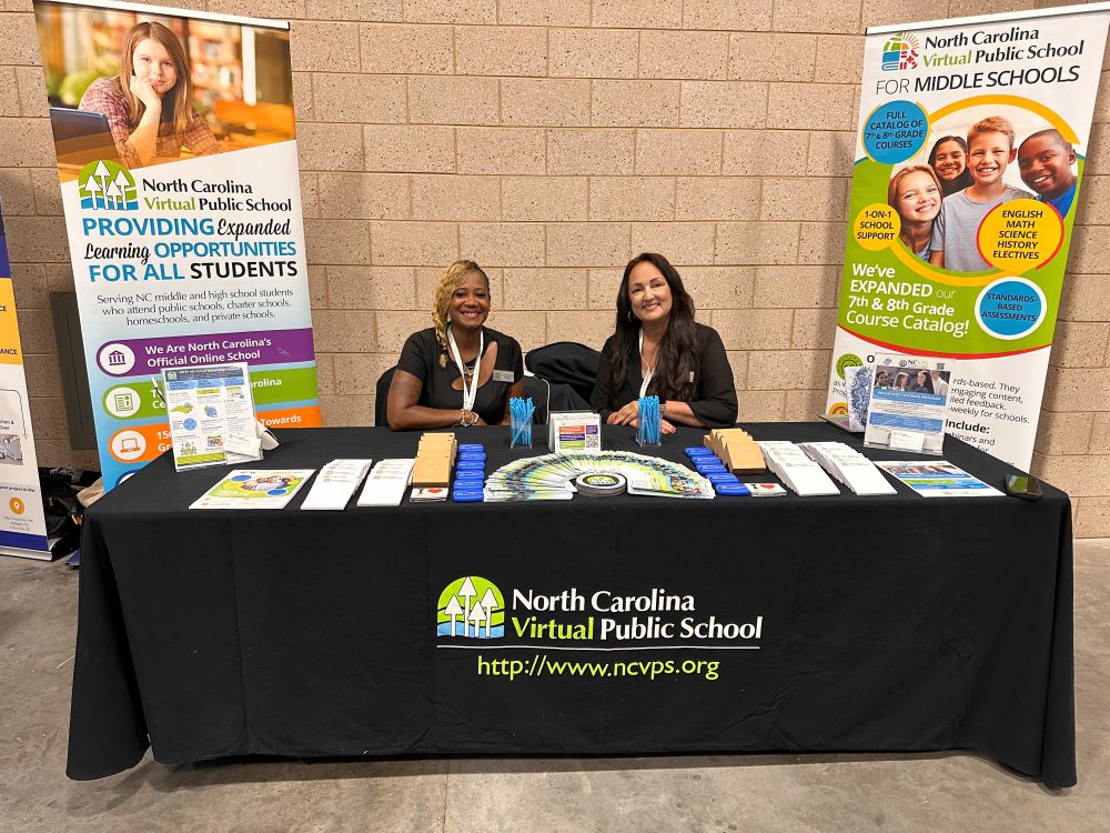 NCVPS Staff at table with NCVPS swag and literature