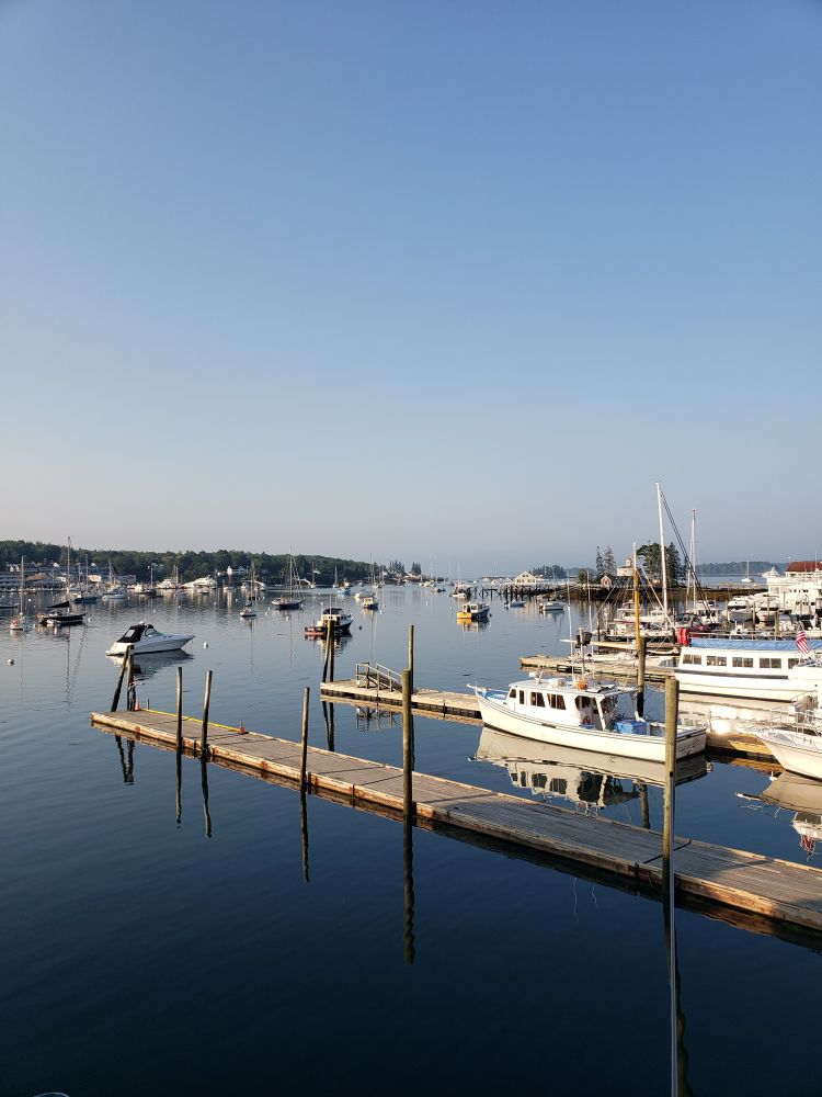 A view of Boothbay harbor filled with boats among the docks.