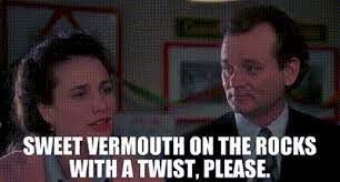 A scene from the movie "Groundhog Day". Andie McDowell speaks while Bill Murray looks at her. Text reads "sweet vermouth on the rocks with a twist, please".