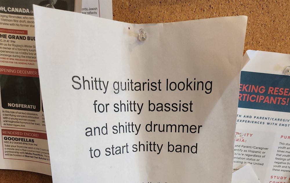 A flyer saying saying "Shitty guitarist looking for shitty bassist and shitty drummer to start shitty band".