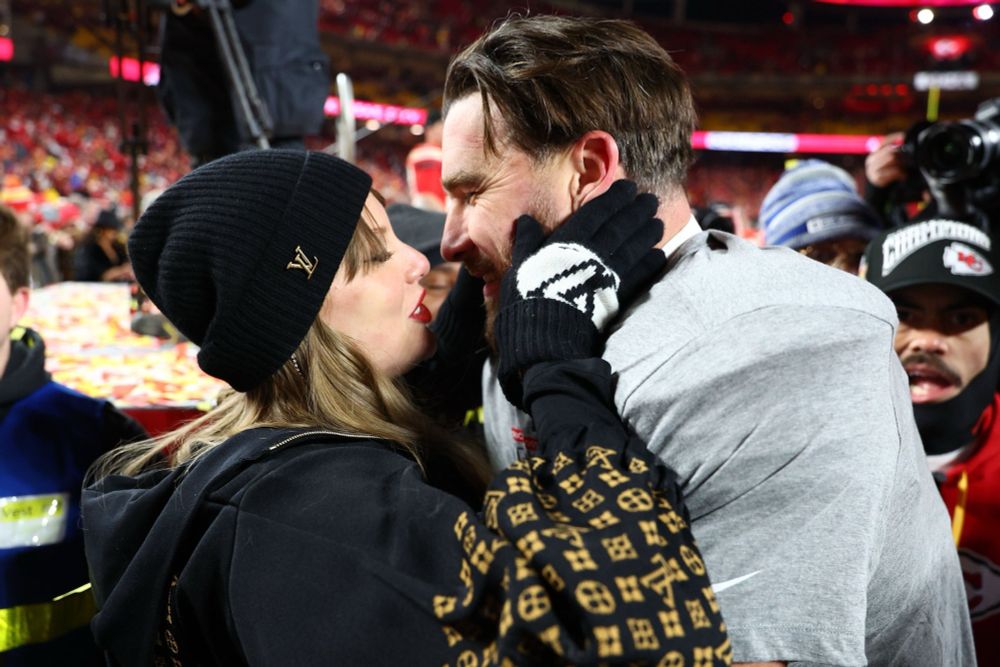 taylor and travis on the field at arrowhead after the afc championship game 