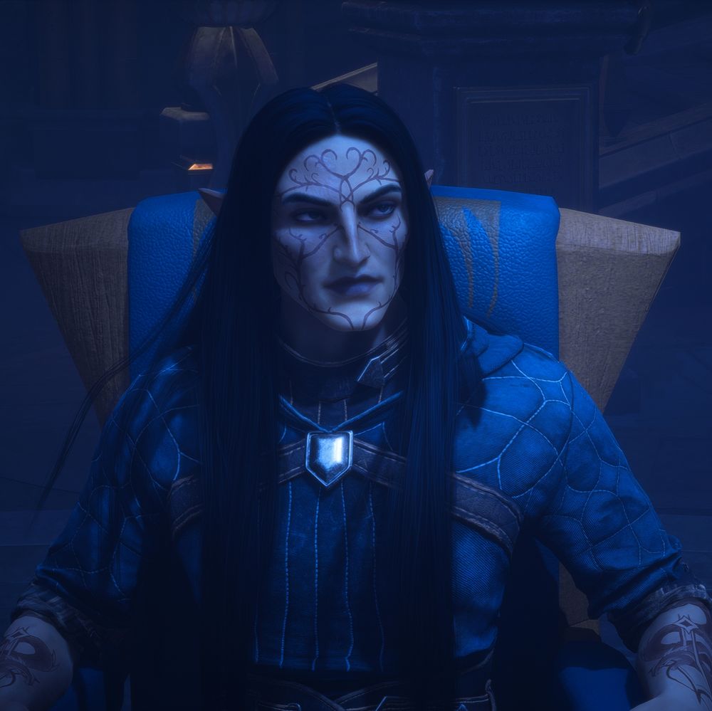 a male elf with long, straight raven black hair is seated in a room with cool lighting, the colors he wears are the blue and grey of the grey warden faction; his facial expression is one of determination and exhaustion; on his sharp facial features there is a prominent nose, a serious mouth with downturned lip corners, arched black eyebrows, slate grey eyes, a red scar on the right side of his face subdued by time and the blood red vallaslin "blood writing" of elgar'nan covering his face on both sides, his skin with a cool tone is quite smooth overall. 