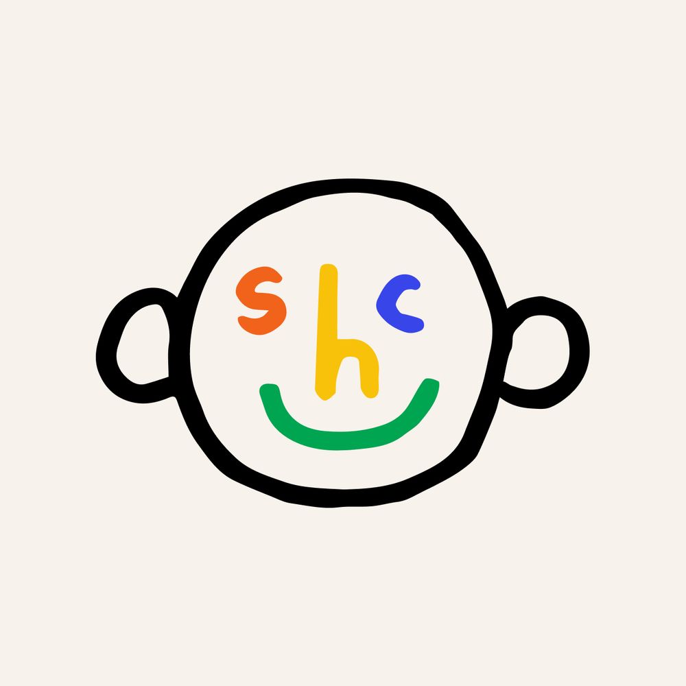 An old logo where i took my initials to make a face with the letters "s" and "c", the "h" as a nose. There are ears, and a big smile, but all the face features are red, yellow, blue, and green.