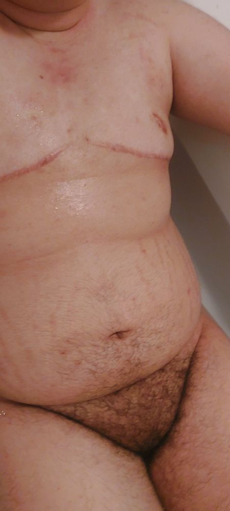 a trans man in the tub relaxing