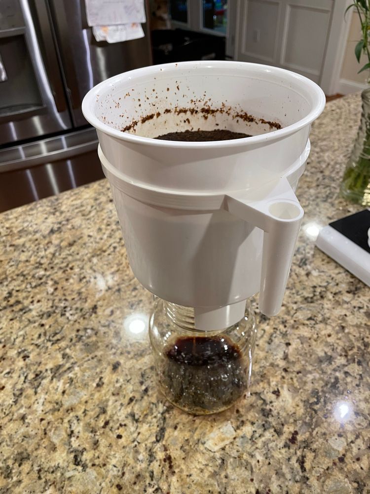 Cold brew coffee dripping into carafe from the Toddy cold brew system
