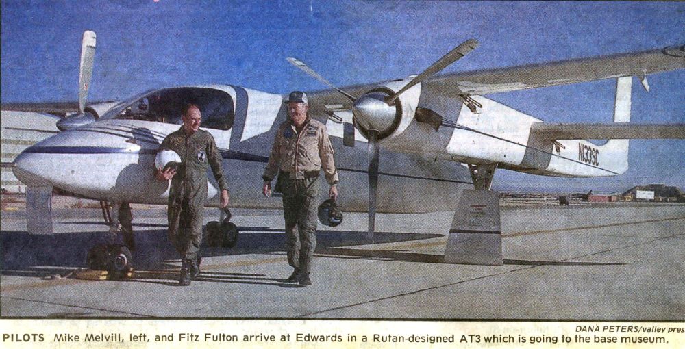 Pilots Mike Melvill and Fitz Fulton walking in front of twin-engine ATTT aircraft after landing at Edwards Air Force Base.
