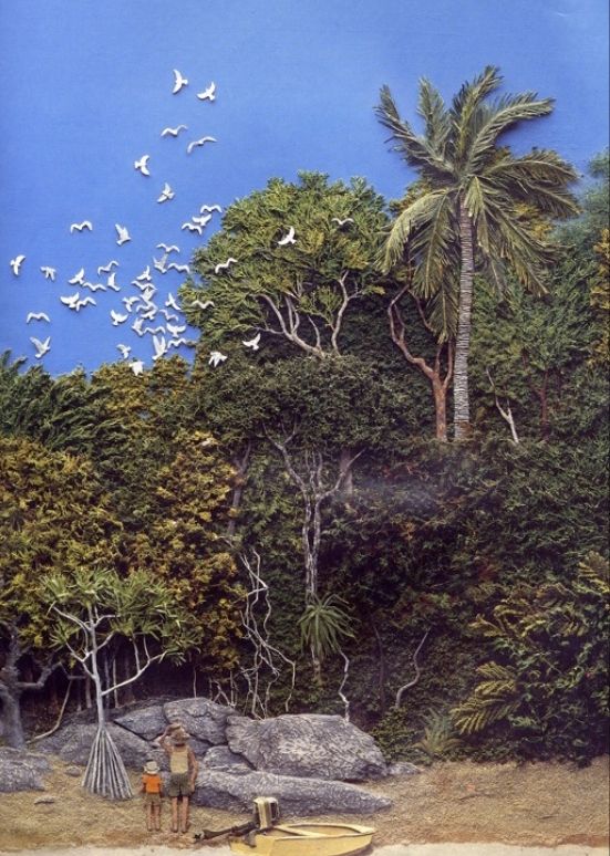 An image from a Jeanie baker picture book (where the forest meets the sea). Two human figures, an adult and child, stand with their backs to the viewer, looking up at the tangle of rainforest as a flock of white birds takes flight from the treetops. This illustration is done in jeanie backers collage style, giving the picture and almost felt-like texture in appearance 