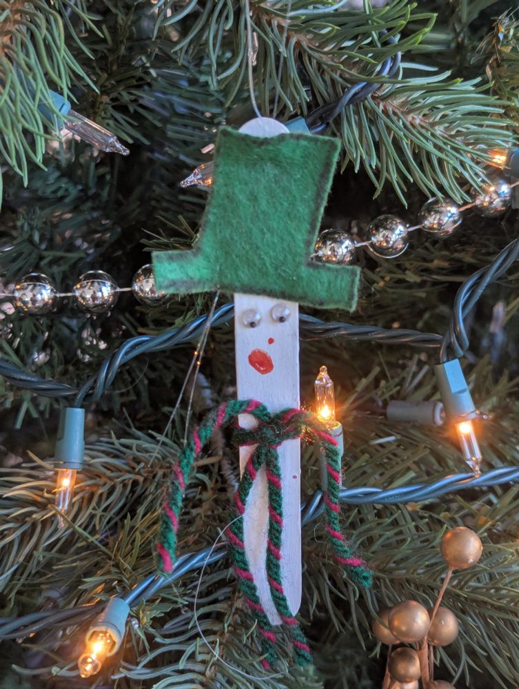 Handmade ornament made by my son Connor in 2005. Throat dispenser snowman with googly eyes and green hat