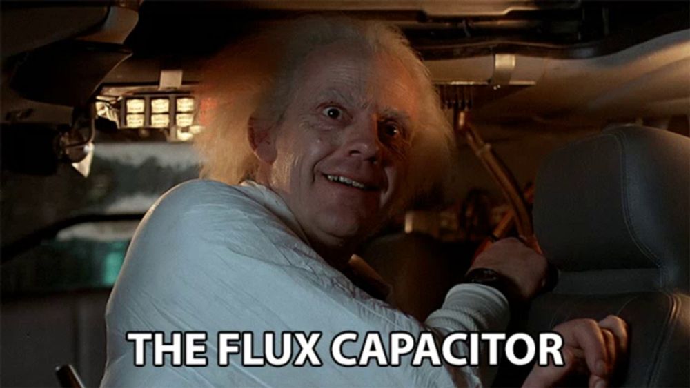 a man in a car with the words " the flux capacitor " below him