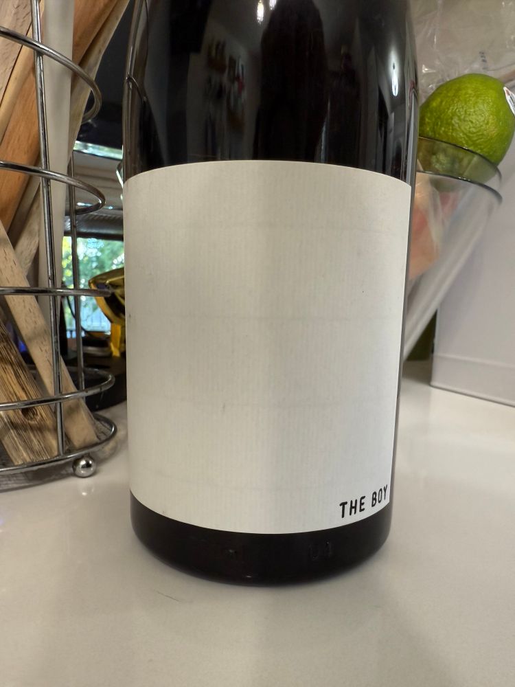 Wine bottle with a label THE BOY