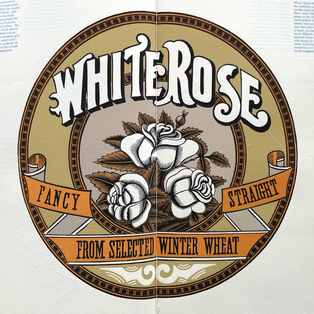 A large circular label printed over the spread of a book. The main name on the label is “White Rose” in a bold, swashy tuscan style. 