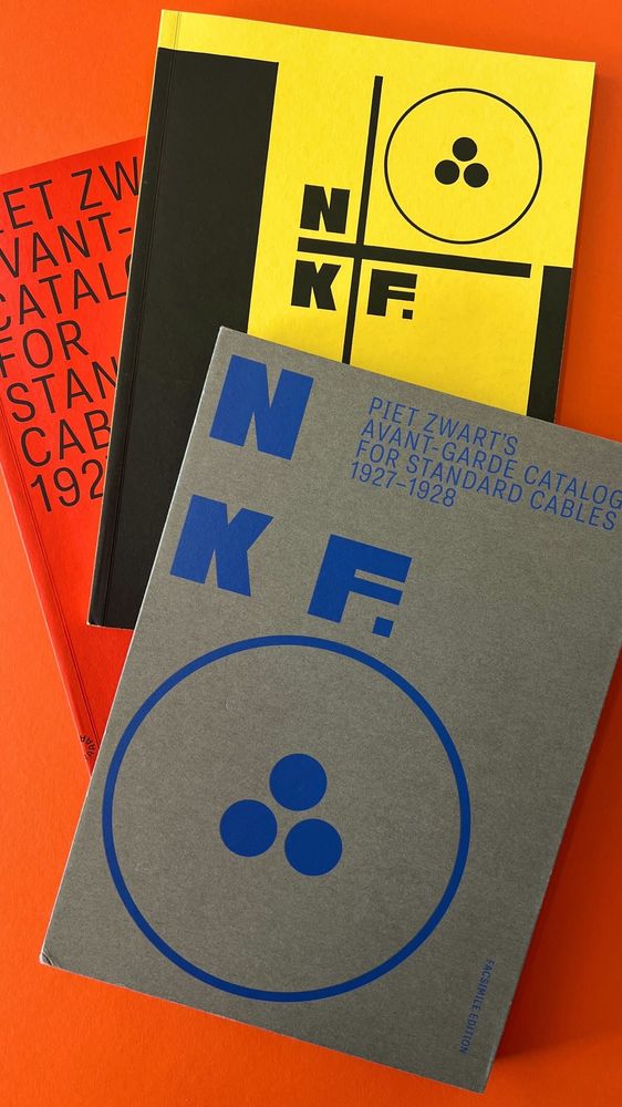 A slipcase and two books on a red background. 