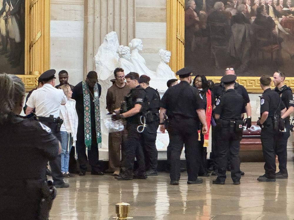 Police arrest clergy in U.S. Capitol rotunda. 