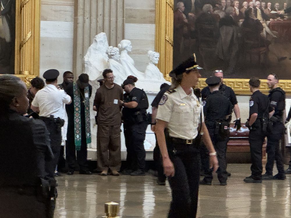Police arrest clergy in U.S. Capitol rotunda. 