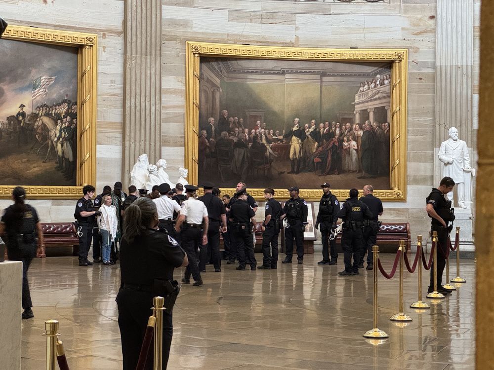 Police arrest clergy in U.S. Capitol rotunda. 