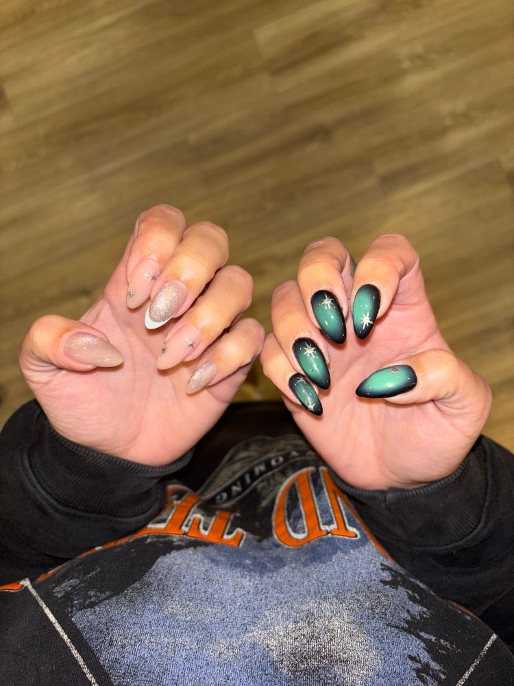 Left hand the nails are soft pink with rhinestones and shimmer and a si fake French. Right hand are black edged with green center and bright, almost comic book style white sparkles on them 