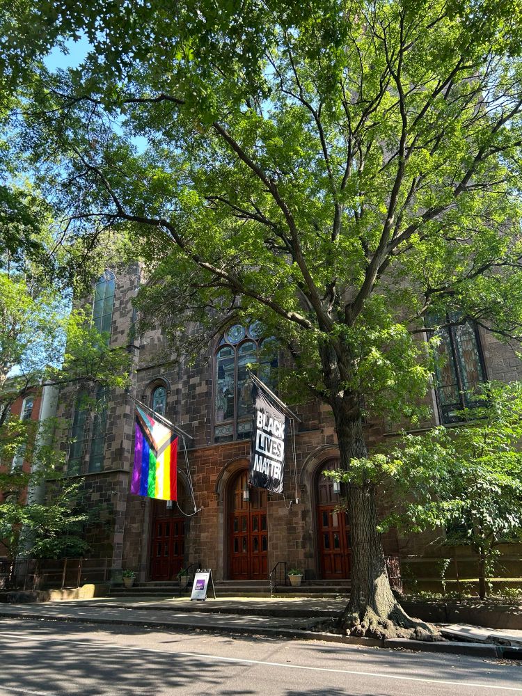A church with a pride flag and Black Lives Matter flag 