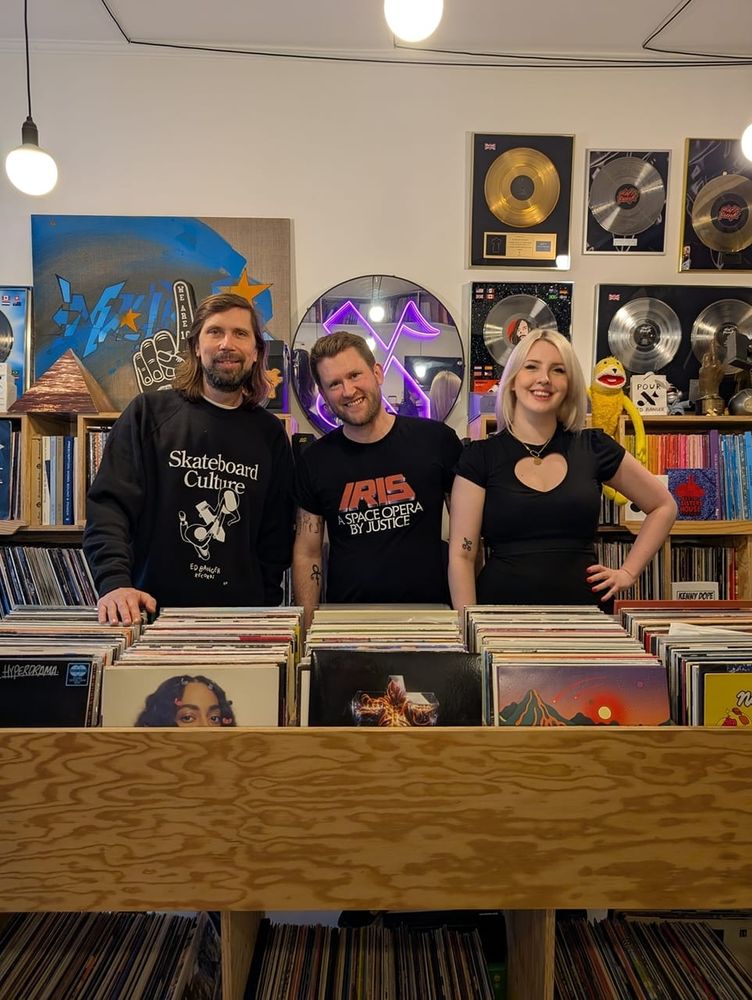 Myself and Charlotte pictured with Ed Banger founder and former Daft Punk manager Pedro Winter at Ed Banger HQ in Paris, which looks like a record store. Daft Punk platinum discs adorn the walls. Flat Eric is peering over Charlotte's shoulder.