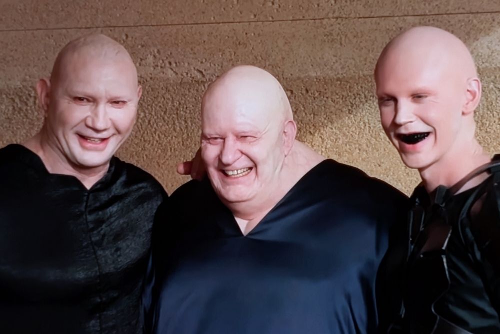 Dave Batista, Stellan Skarsgard, and Austin Butler all in makeup as their characters in Dune posing and smiling for a behind the scenes photo 