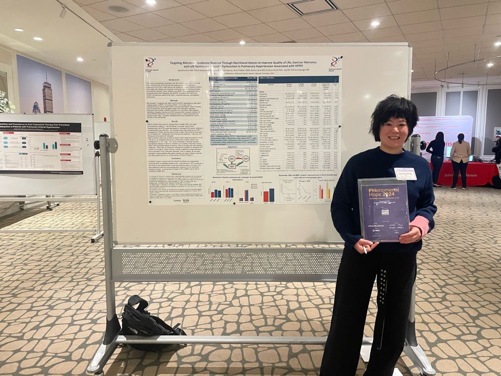 Dr. Darlene Kim standing in front of a medical conference poster that describes using a well formulated ketogenic diet in the treatment of patients with metabolic syndrome-associated HFpEF. 