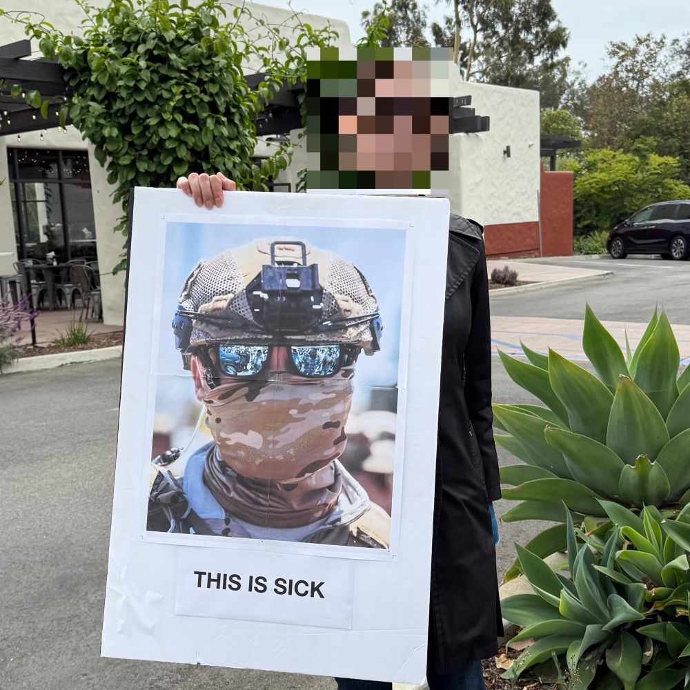 A photo of, presumably, an ICE agent in camouflage and mirrored glasses and a full gaiter, camo face covering. Below the photo the words, “This is sick!”
